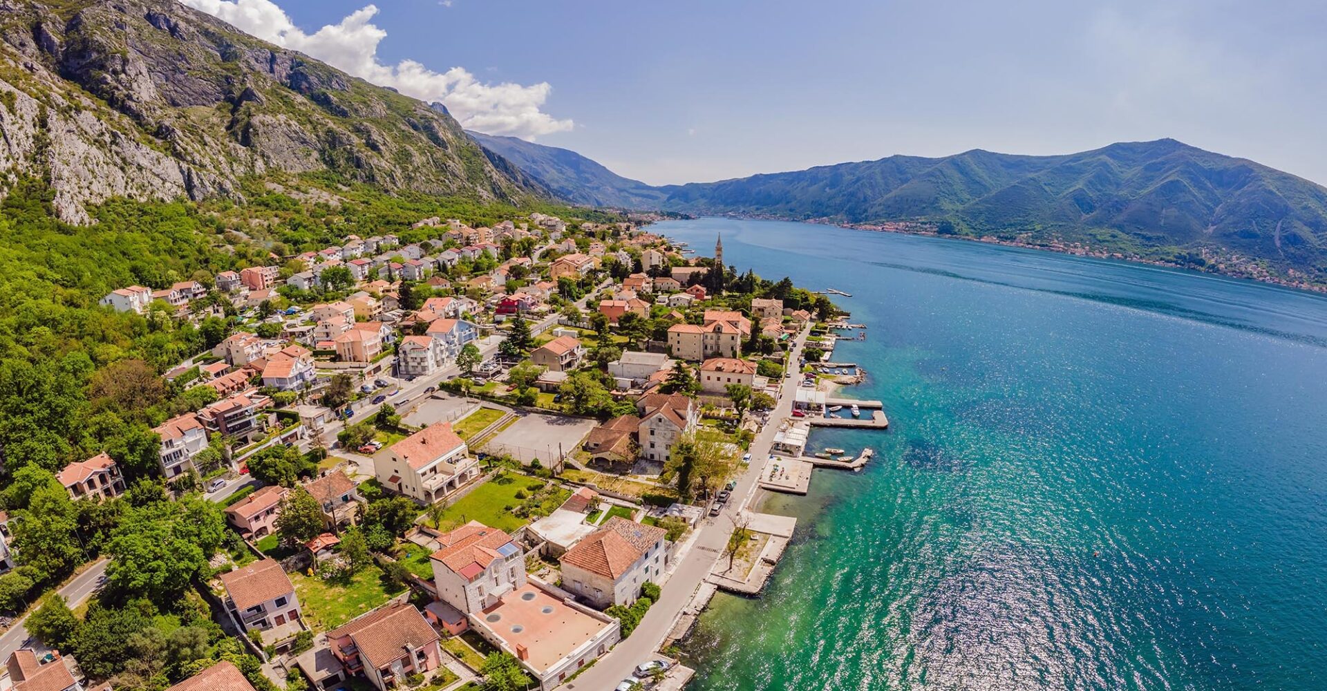 Montenegro. Boka Kotor Gulf. View on the picturesque coastal town of Dobrota, the Institute of Marine Biology and the Church of St. Ilijah